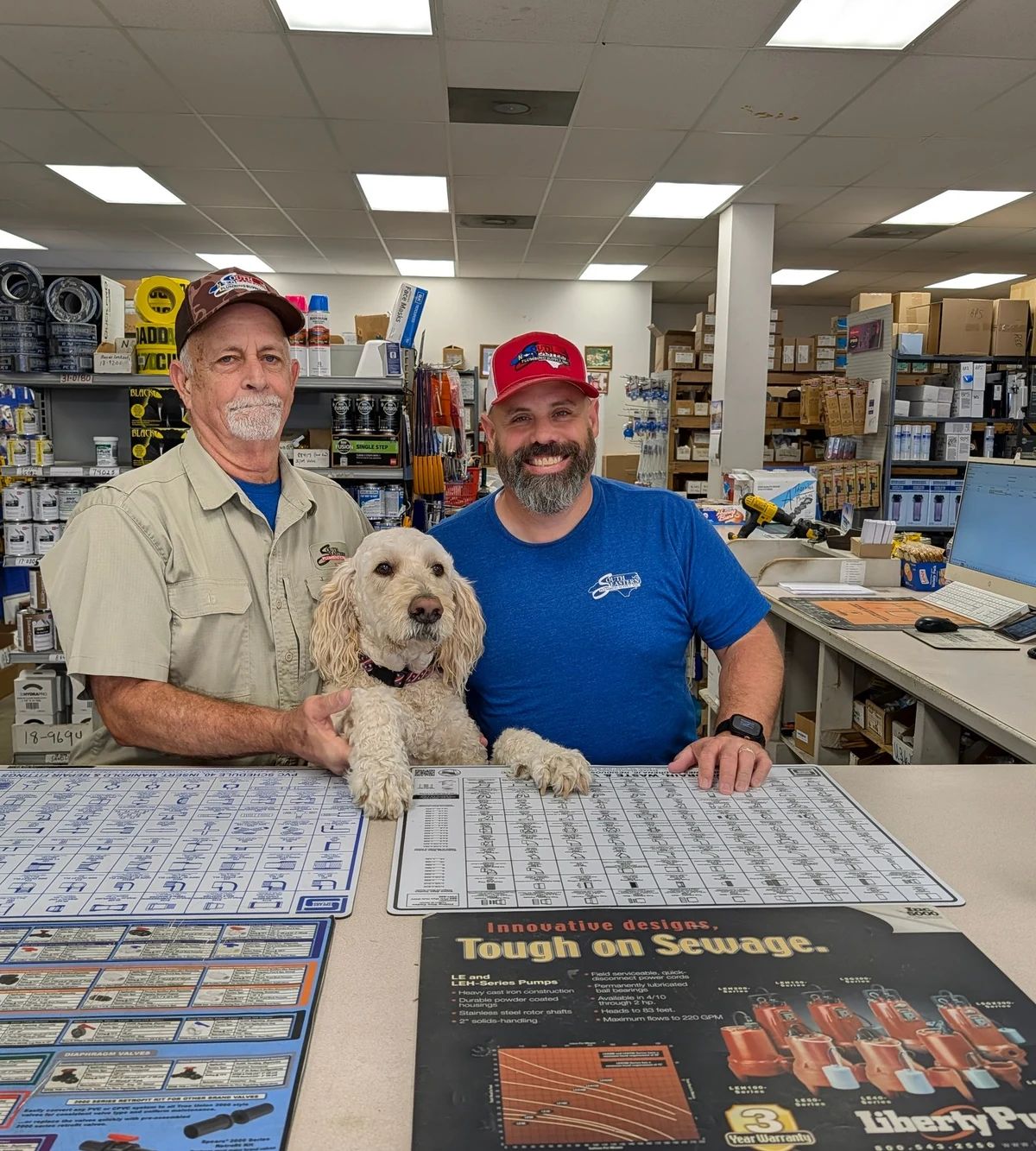 Ricky and Travis behind the counter with Bentley between them